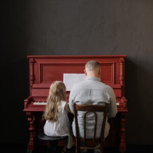 girl and man playing piano